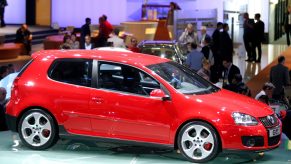 A red Volkswagen Golf 5 three door hatchback