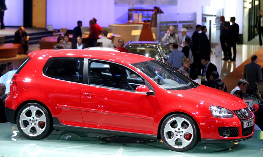 A red Volkswagen Golf 5 three door hatchback