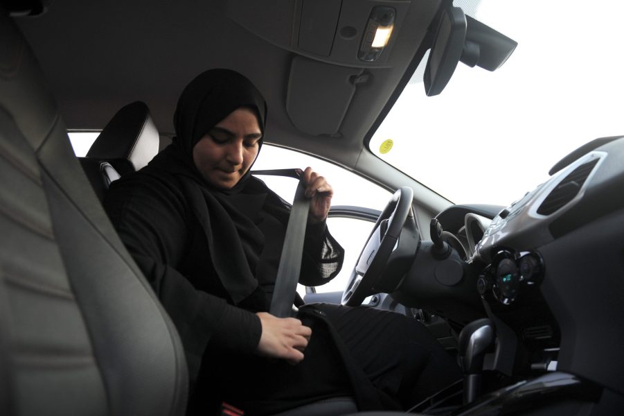 A woman buckles her seatbelt