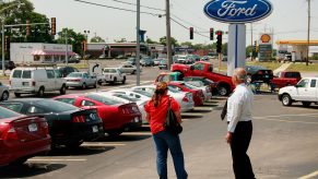 A saleman helps out a customer at a Ford dealership August 3, 2009 in Downers Grove, Illinois.