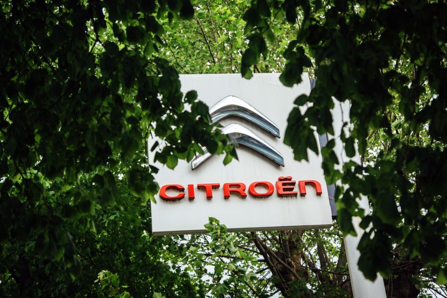 A citroen sign through the trees