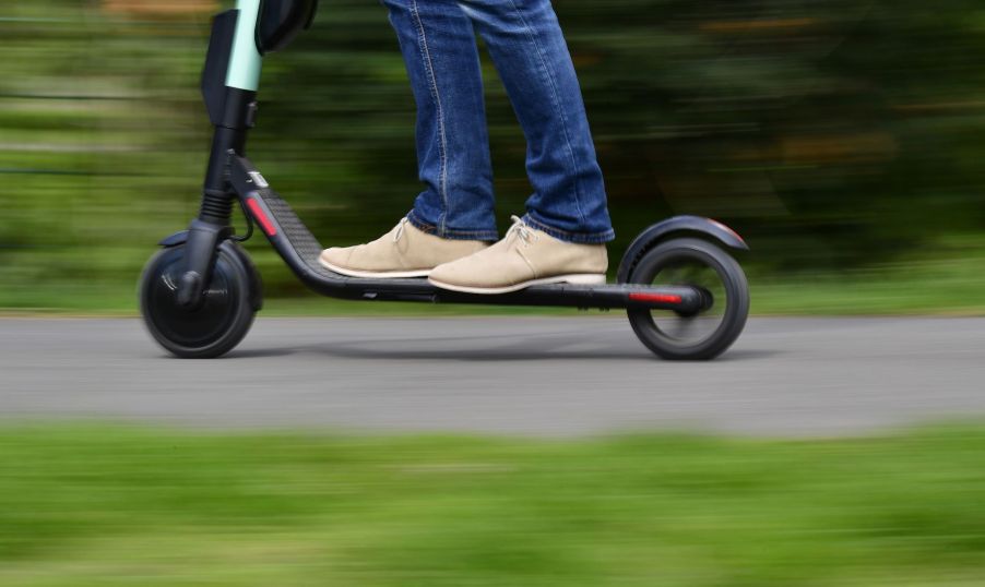 A man rides an E-Scooter of rental company Tier in Berlin on April 17, 2019. - German ministers agreed rules for using battery-powered scooters on the country's roads, paving the way for the two-wheeled craze to spread further across Europe. (Photo by Tobias SCHWARZ / AFP) (Photo by TOBIAS SCHWARZ/AFP via Getty Images)