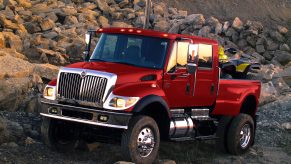 The international CXT is one of the biggest pickup trucks ever made and this one is parked on the side of a mountain and painted red