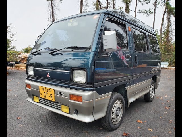 a green Mitsubishi Bravo microvan