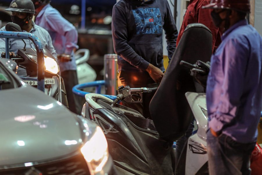 A customer refuels his motorcycle