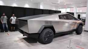 A steele Tesla Cybertruck electric pickup on display indoors