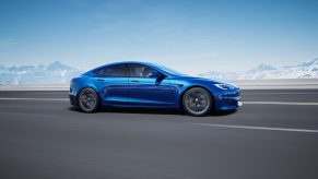 blue Tesla Model S sedan with blue sky and no background