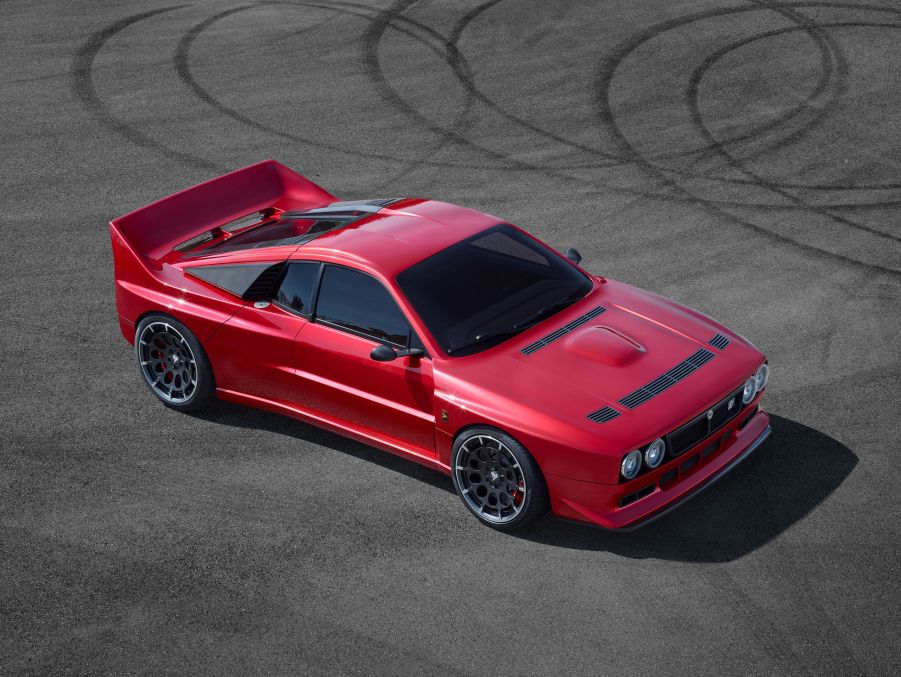 The red EVO37 sits on tarmac with tire tracks from donuts behind