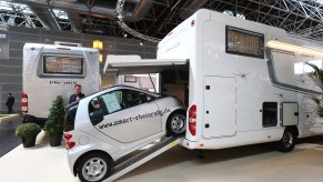 A SmartCar on a ramp leading into a toy hauler motorcoach at Caravan Salon Duesseldorf expo in Germany on September 4, 2014