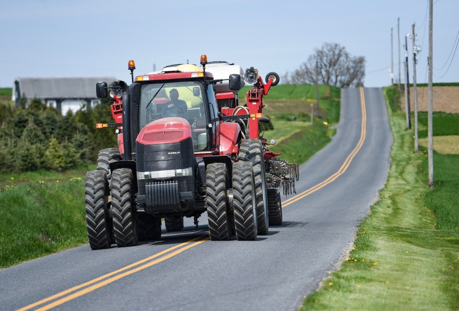 David Wolfskill drives a Case tractor pulling a corn planter on a street outside his Pennsylvania farm