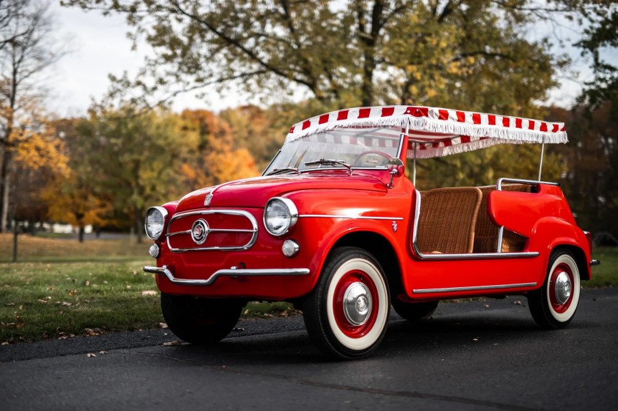 A red 1958 Fiat Jolly 600 parked on a driveway