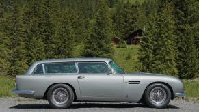 The silver Aston Martin DB5 Shooting Brake among the trees