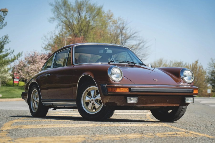 The front 3/4 view of a brown 1975 Porsche 911 S in a parking lot