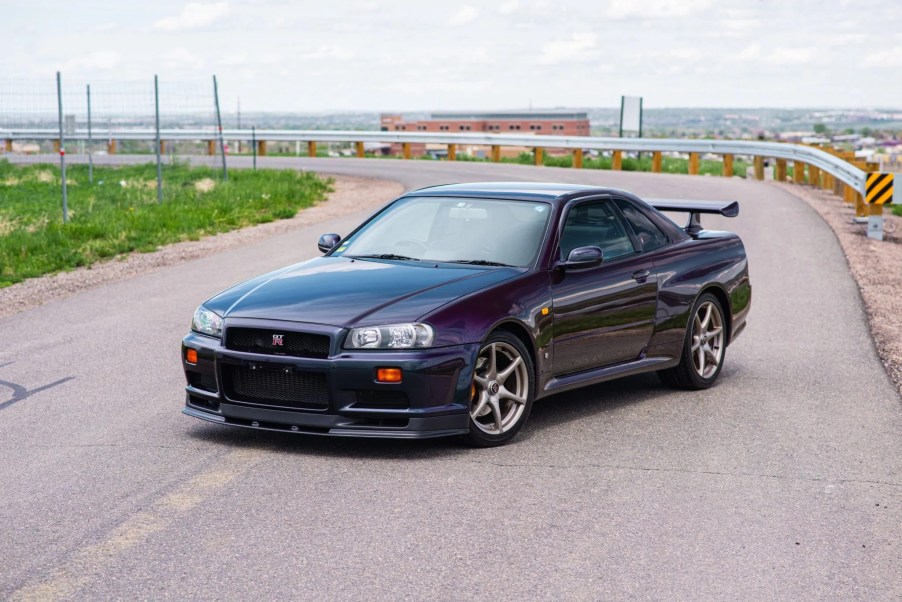 A Midnight Purple II 1999 R34 Nissan Skyline GT-R V-Spec on a road