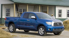 A blue 2007 Toyota Tundra by a farmhouse