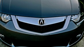 A closeup of the grille, headlights, and front bumper of a black 2008 Acura TSX luxury sedan in Los Angeles in April 2008