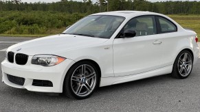 A white 2013 BMW 135is Coupe in a parking lot