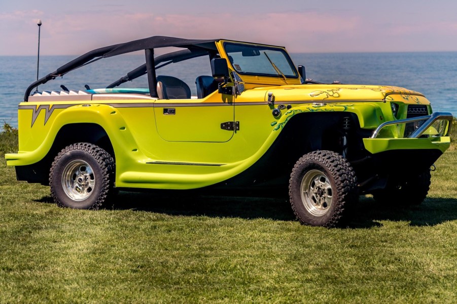 A yellow-gray-and-green 2016 WaterCar Panther on a field by a body of water