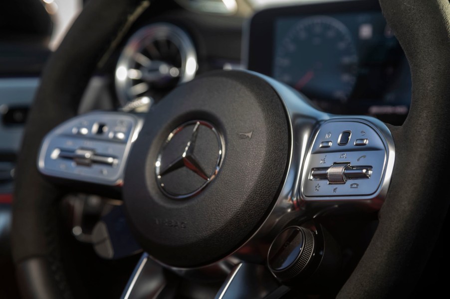 A close-up of a 2020 Mercedes-Benz CLA 45 sedan's black and silver ​steering whee