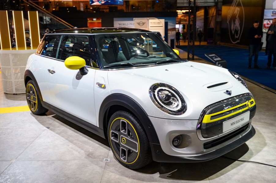 A white, yellow, and black 2020 Mini Cooper SE electric car on display at Brussels Expo in January 2020