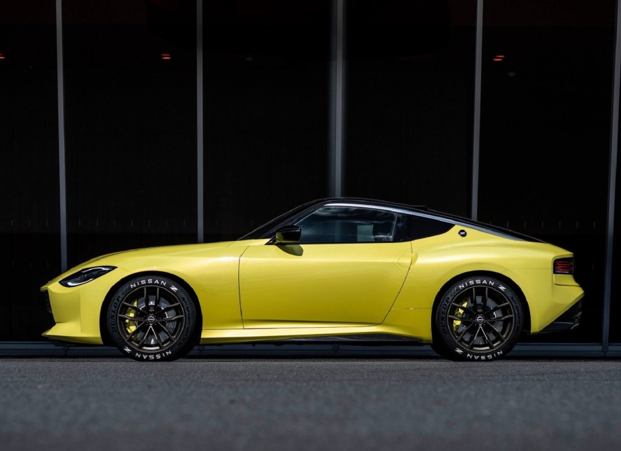 The side view of the yellow 2020 Nissan Z Proto Concept in front of a black building