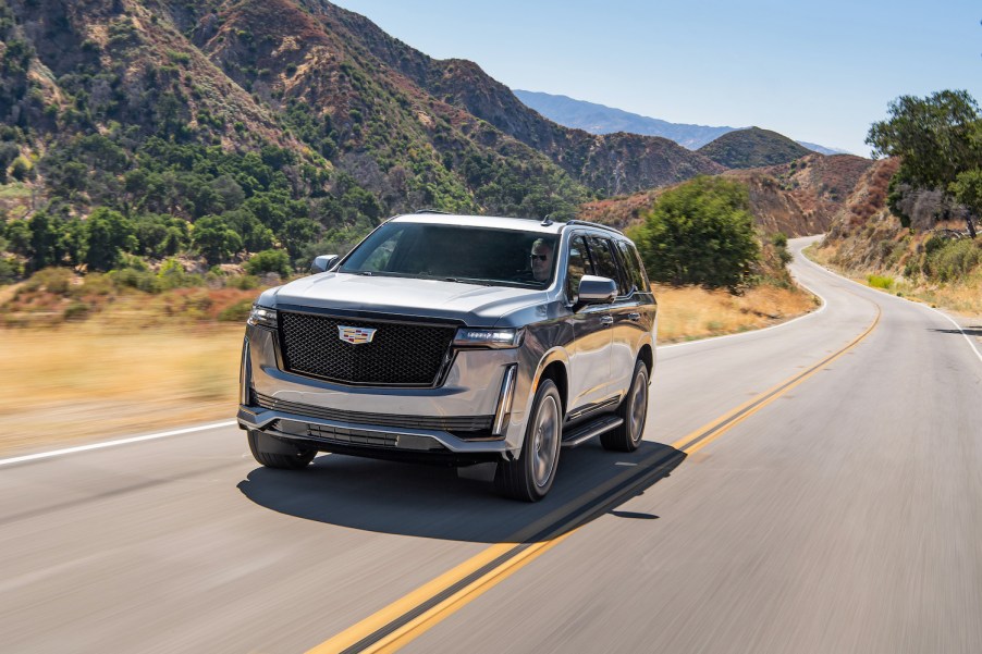 A 2021 Cadillac Escalade driving down a curvy road