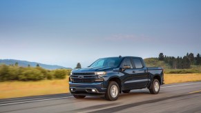 A dark blue 2021 Chevrolet Silverado RST driving, the Silverado is one of the best new diesel trucks