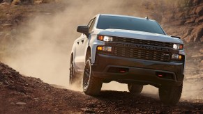 A white 2021 Chevy Silverado 1500 off-roading in dirt