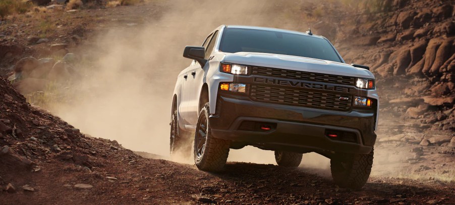 A white 2021 Chevy Silverado 1500 off-roading in dirt