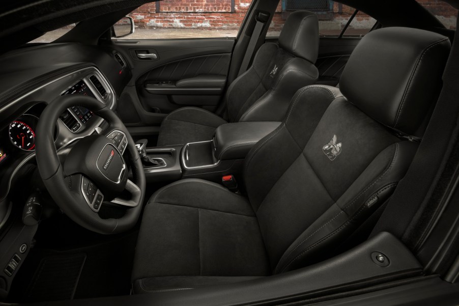 A 2021 Dodge Charger sedan's black cloth performance seats with an embroidered Scat Pack Bee logo