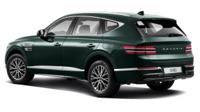 A dark-green 2021 Genesis GV80 luxury midsize SUV on a white background