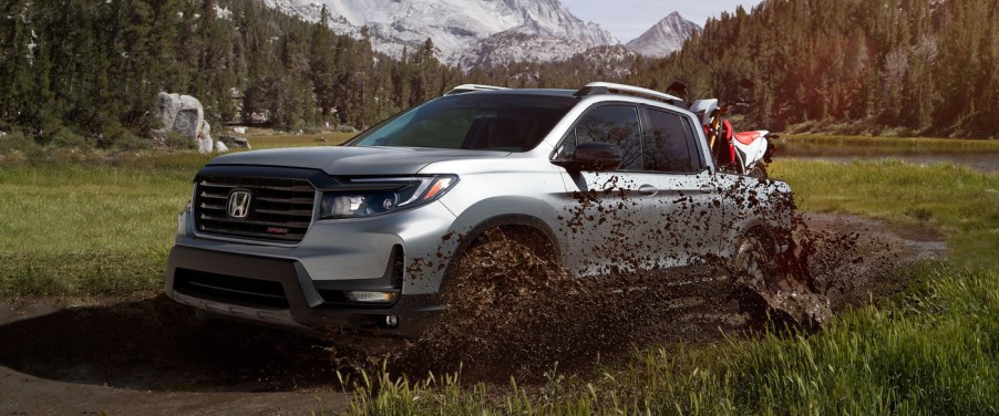 The 2021 Honda Ridgeline in a field driving off-road