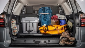 A 2021 Toyota 4Runner SUV's tailgate is open to reveal hiking equipment