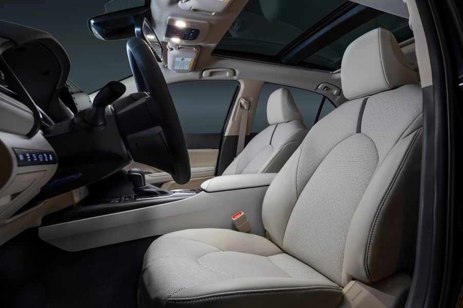 The gray ventilated front seats of a 2021 Toyota Camry XLE midsize sedan