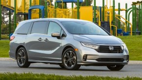 A gray 2022 Honda Odyssey minivan is parked near a jungle gym.