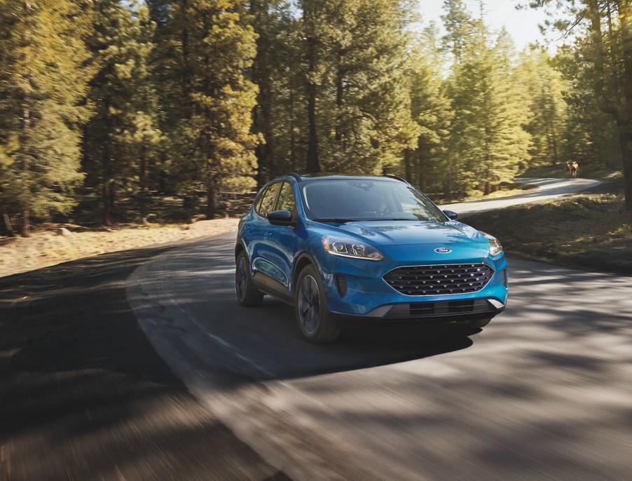 A blue 2021 Ford Escape Hybrid driving