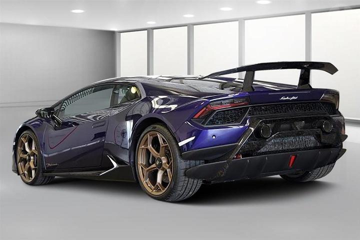 An image of a purple Lamborghini Huracan Performante held for auction.