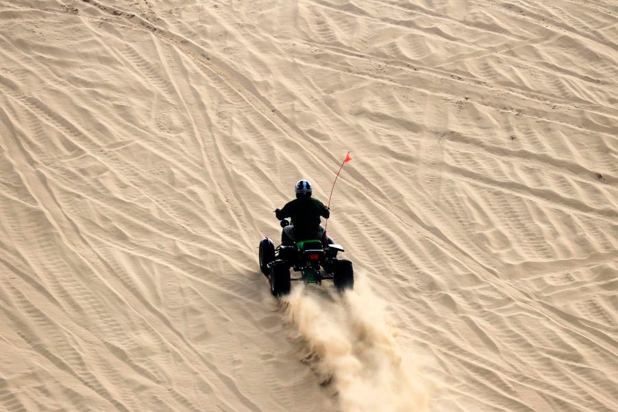 An ATV travels on a sand dune in a designated off-road vehicle area in the Oregon Dunes National Recreation Area