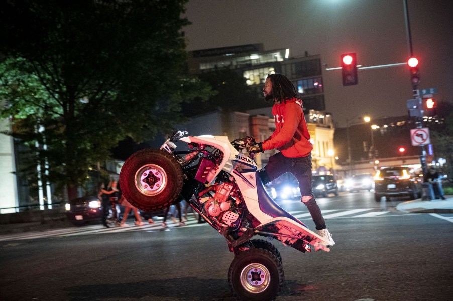 A man rides an ATV on U Street in Washington, D.C., the night of June 11, 2021