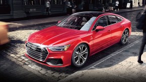 A red Audi A7 parked in a city.