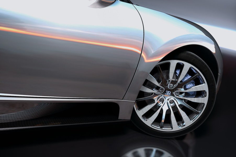 A closeup of a silver Bugatti Veyron's right front tire and passenger door