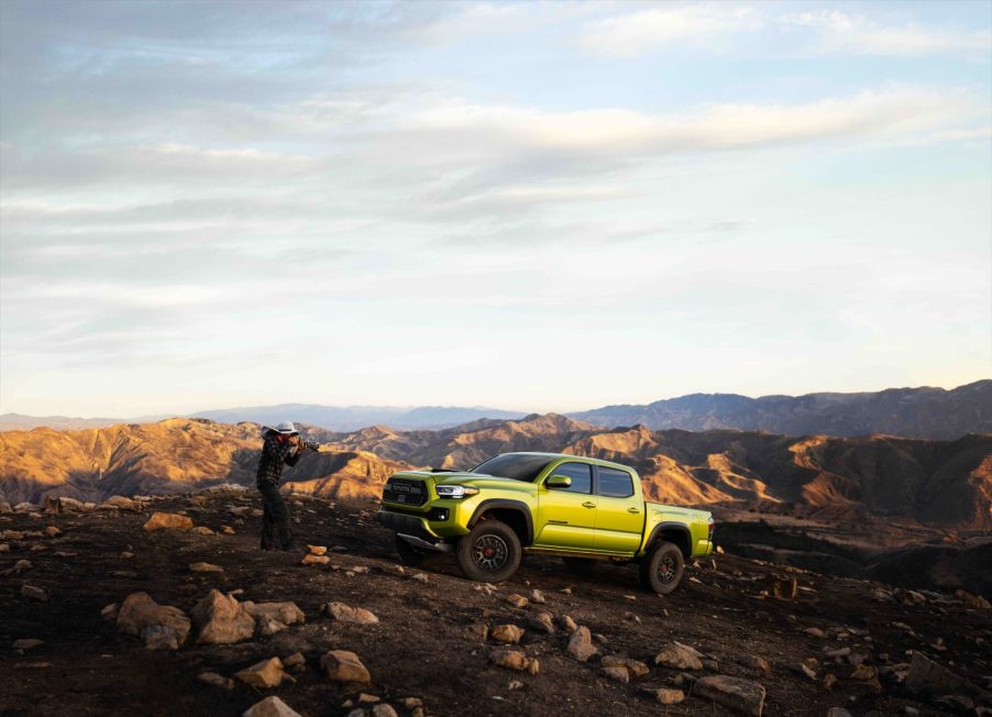 A photographer snapping the 2022 Toyota Tacoma TRD Pro on a mountain