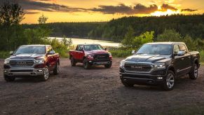 three ecodiesel 2021 ram 1500 models in gravel near a wooded lakeshore.