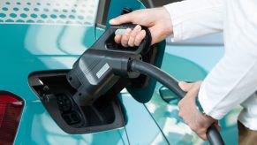 A user charges a Volkswagen ID.3 electric vehicle at a charging station in the city of Dresden.