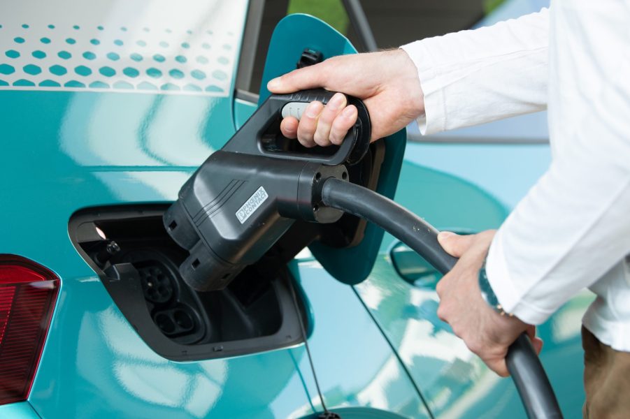 A user charges a Volkswagen ID.3 electric vehicle at a charging station in the city of Dresden.