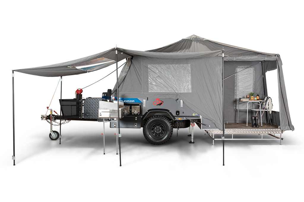 the cub explorer camper trailer set up for a press photo with the tent erected against a white backdrop