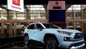 A grey Lunar Rock Toyota RAV4 on display in a booth