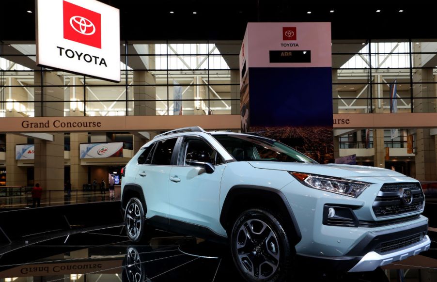 A grey Lunar Rock Toyota RAV4 on display in a booth