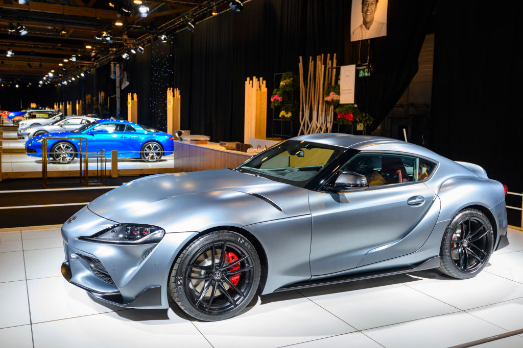 The A91 Toyota Supra sits under the lights at an auto show