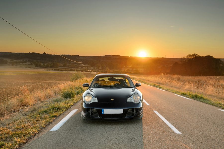 A black Porsche 996-generation 991 as sunset